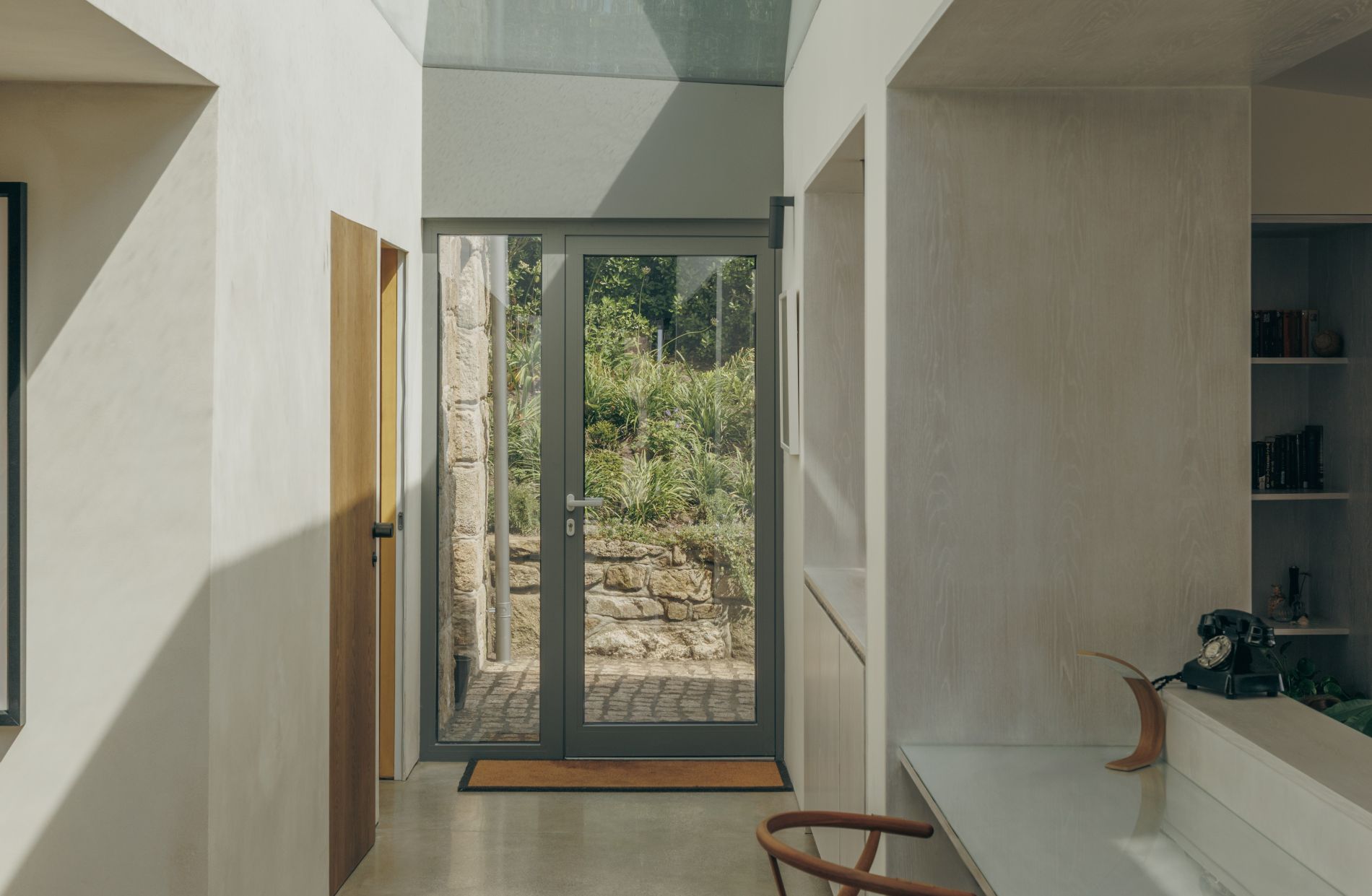 Glazed entrance hall linking the granite cottage and contemporary extension on Bryher