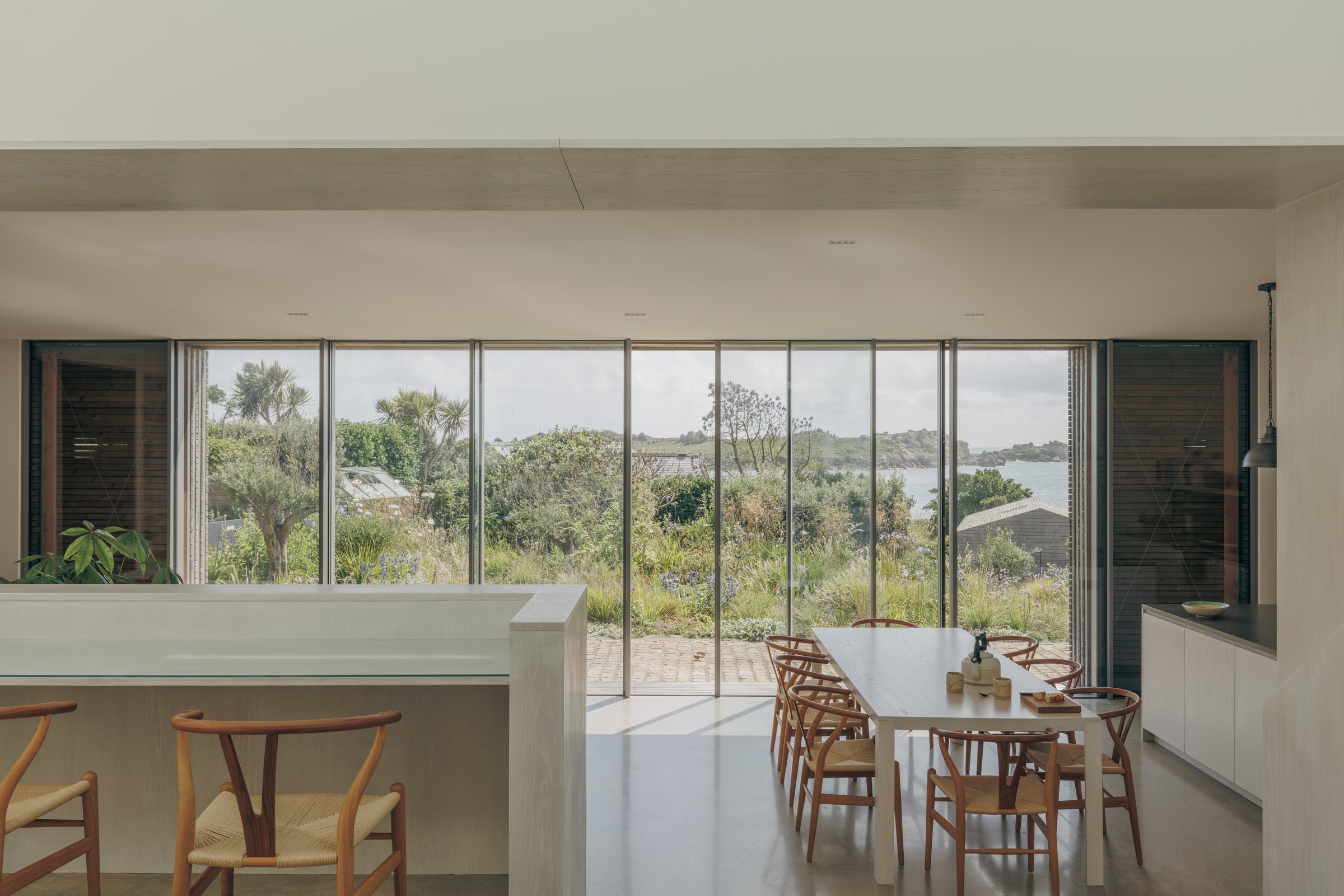 Open-plan living and dining space overlooking the garden and sea at Bank Cottage