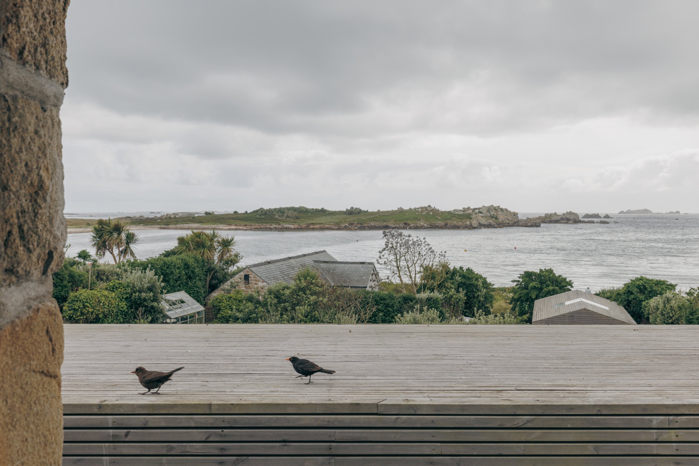 View over the terrace and garden towards the sea and islands from Bank Cottage