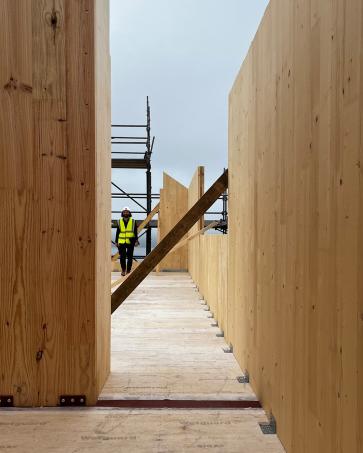The houses are taking shape in Tongue.

The first CLT structures, manufactured off-site by Egoin, are now being craned into position, marking an important stage in the construction.

The larch structure will remain exposed internally, wrapped in woodfibre insulation and larch cladding, carrying timber through from structure to finished surface.

Above stone-built ground floors set into the hillside, the lighter timber upper levels open towards expansive views across the Kyle of Tongue.

The gardens will extend the surrounding moorland around the buildings, helping them bed into the wider landscape.

#scottisharchitecture #ruralarchitecture #ruralhousing #highlandarchitecture #sutherland #tongue